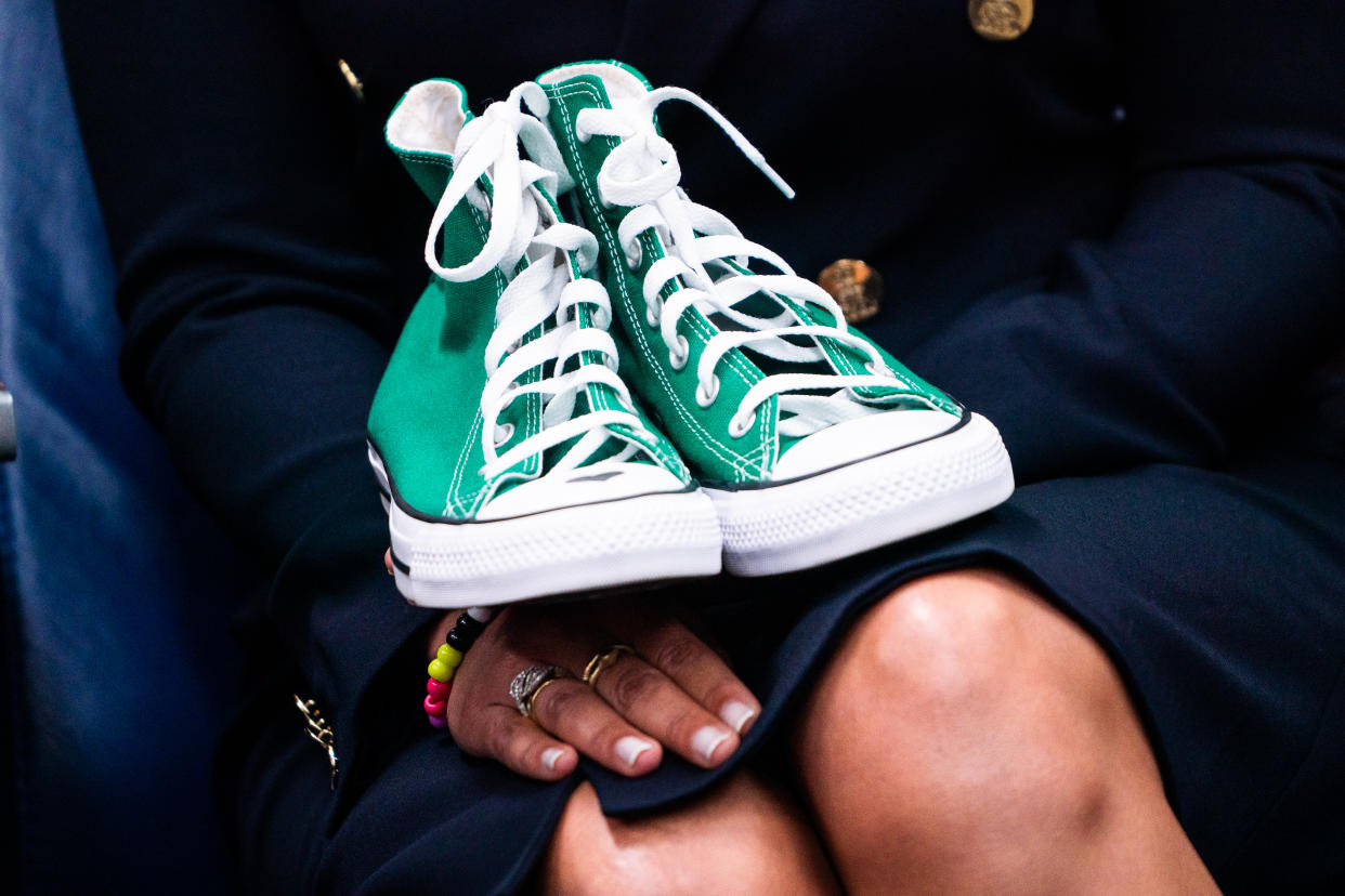 Matthew McConaughey's wife, Camila Alves, holds a pair of green Converse tennis shoes similar to ones worn by ten-year-old Uvalde shooting victim Maite Rodriguez. (Photo by Demetrius Freeman/The Washington Post via Getty Images)