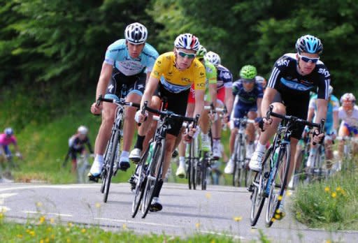 Yellow jersey leader British Bradley Wiggins (C) rides in the sixth stage of the 64rd edition of the Dauphine Criterium cycling race between Saint-Aban-Leysse and Morzine, French Alps