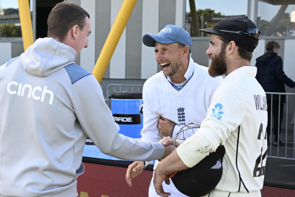 New Zealand's Kane Williamson, right, shares a laugh with England's Harry Brook, left, and Joe Root at the end of day 5 of their cricket test match in Wellington, New Zealand, Tuesday, Feb 28, 2023. (Andrew Cornaga/Photosport via AP)