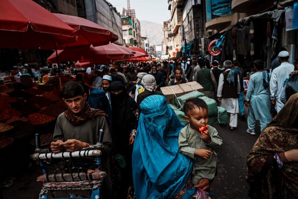 Shoppers at an outdoor market in Kabul