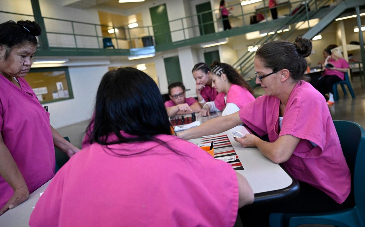 Female inmates play cards