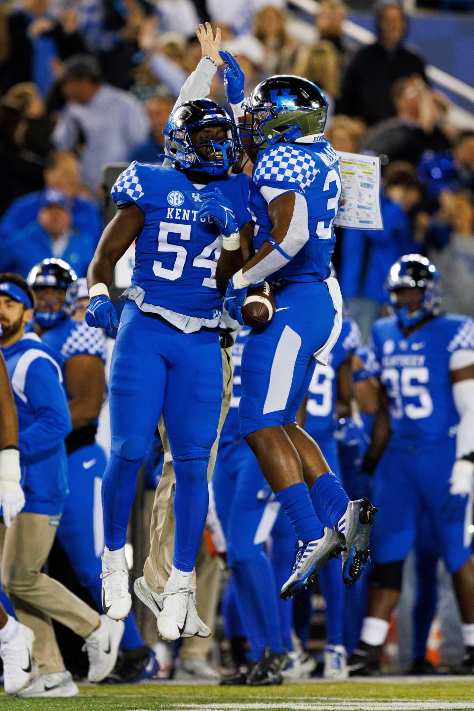 Kentucky linebacker D'Eryk Jackson (54) celebrates with linebacker Trevin Wallace (32) after forcing a turnover by South Carolina during the first half of an NCAA college football game in Lexington, Ky., Saturday, Oct. 8, 2022. (AP Photo/Michael Clubb)
