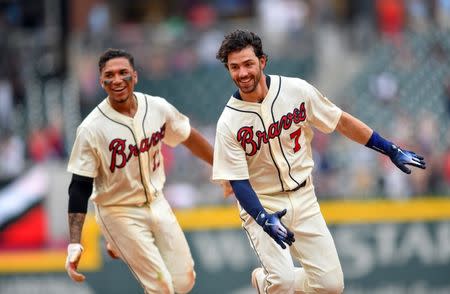 May 20, 2018; Atlanta, GA, USA; Atlanta Braves shortstop Dansby Swanson (7) reacts with third baseman Johan Camargo (17) after getting the game winning hit against the Miami Marlins during the ninth inning at SunTrust Park. Mandatory Credit: Dale Zanine-USA TODAY Sports