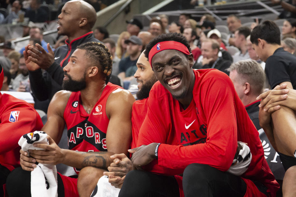 Toronto Raptors' Pascal Siakam, right, laughs on the bench during the second half of the team's NBA basketball game against the San Antonio Spurs, Wednesday, Nov. 2, 2022, in San Antonio. The Raptors won 143-100. (AP Photo/Darren Abate)