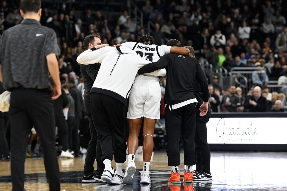 Providence Friars forward Bryce Hopkins is helped by staff after injuring his left knee during the second half against Seton Hall.