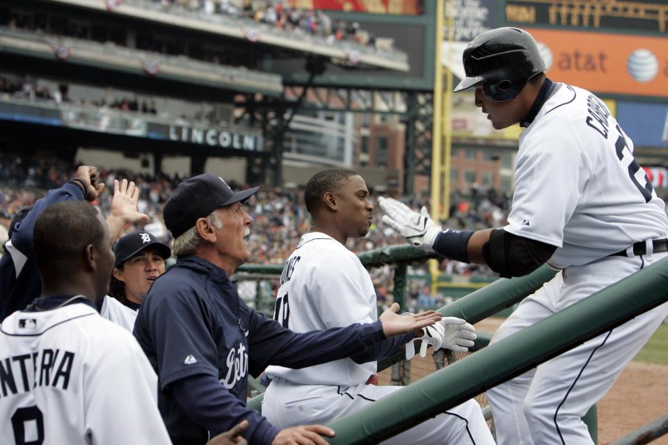 Detroit Tigers Miguel Cabrera gets a hand from from his teammates in the dugout including Manager Jim Leyland, 2nd from left, after Cabrera's solo HR gave the Tigers a 3-0 lead in the 5th inning over the  Kansas City Royals on Opening Day in Detroit, MI on Monday, March 31, 2008.
