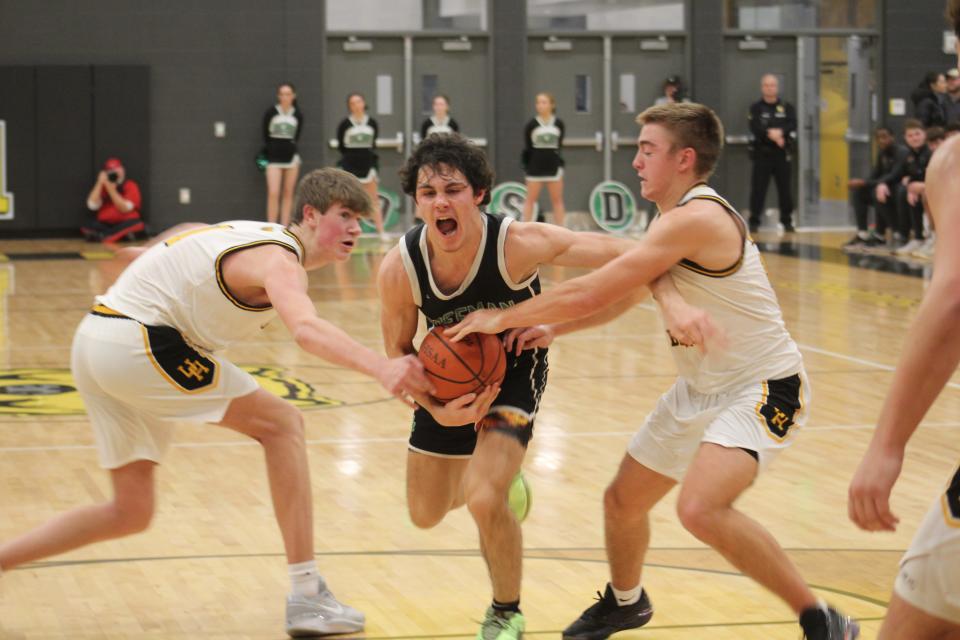 Upper Arlington’s Alex Smith, left, and Zach Corna defend Dublin Coffman’s Colin McClure during Friday's game.