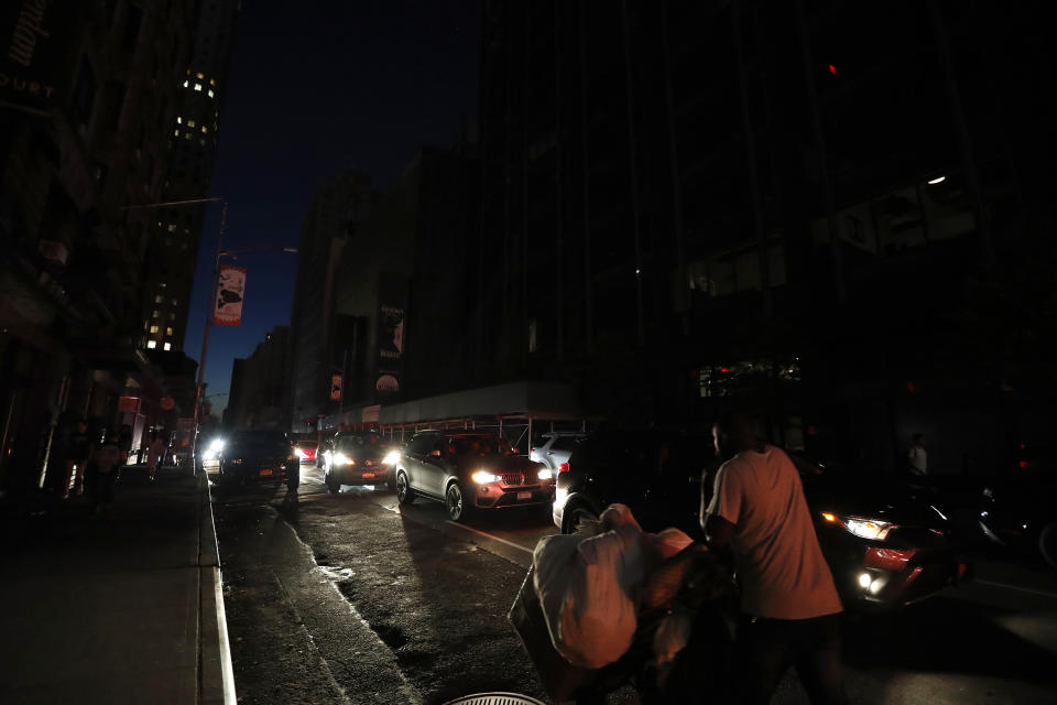 A man makes his way through a dark Times Square during a power outage, Saturday, July 13, 2019, in New York. Authorities were scrambling to restore electricity to Manhattan following a power outage that knocked out Times Square's towering electronic screens and darkened marquees in the theater district and left businesses without electricity, elevators stuck and subway cars stalled. (Photo: Michael Owens/AP)