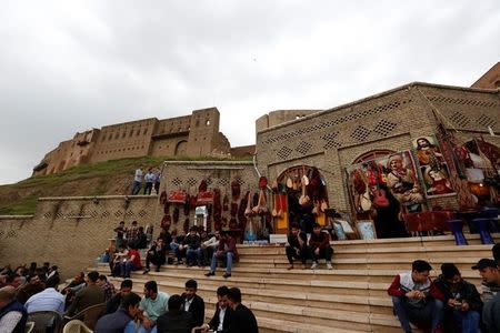 Kurdish people sit in a coffee shop in front of Erbil Citadel, Iraq April 14, 2017. REUTERS/Jamal Saidi/Files