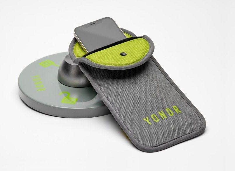 A cell phone in a "Yondr pouch," named for the company, Yondr, founded in 2014, at an unlocking station.