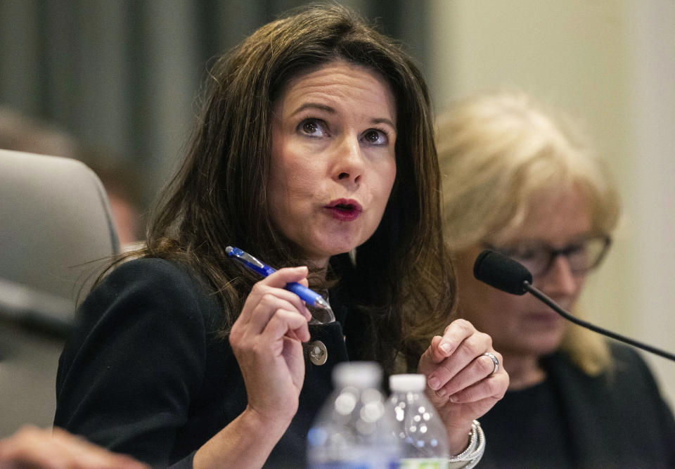 Kim Westbrook Strach, left, executive director of the Bipartisan State Board of Elections & Ethics Enforcement, questions a witness during the second day of a public evidentiary hearing on the 9th congressional district voting irregularities investigation Tuesday, Feb. 19, 2019, at the North Carolina State Bar in Raleigh, N.C. North Carolina elections officials looking into ballot fraud in the country's last undecided congressional election are finding that votes were counted days ahead of Election Day in the rural county at the center of disputed results. (Travis Long/The News & Observer via AP, Pool)