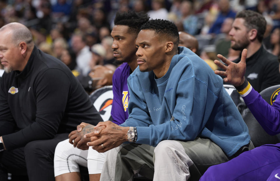 Los Angeles Lakers guards Russell Westbrook, front, and Malik Monk look on from the bench in the first half of an basketball game against the Denver Nuggets Sunday, April 10, 2022, in Denver. (AP Photo/David Zalubowski)