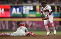 Philadelphia Phillies' J.T. Realmuto, left, steals second base as Atlanta Braves' Ozzie Albies watches during the first inning of a baseball game Sunday, May 9, 2021, in Atlanta. (AP Photo/Ben Margot)
