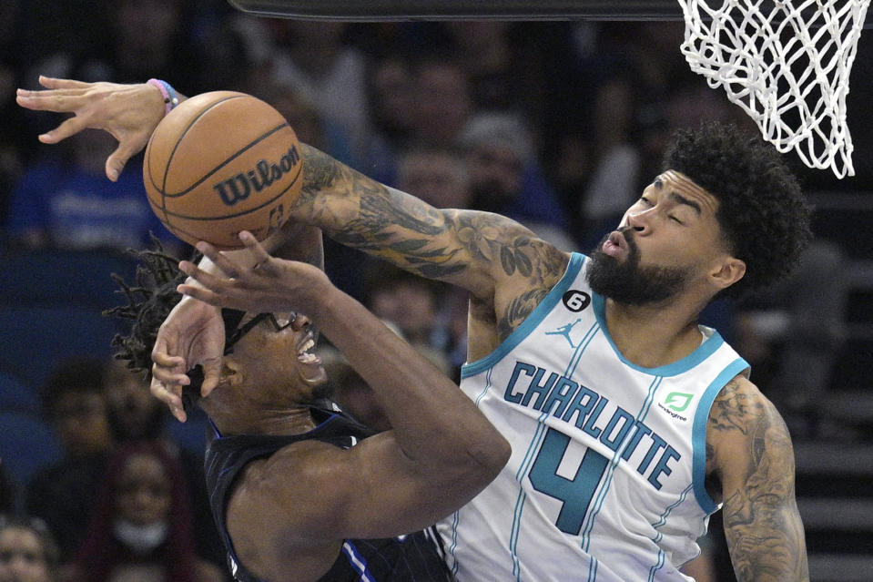 Orlando Magic center Wendell Carter Jr., left, is fouled by Charlotte Hornets center Nick Richards (4) while shooting during the second half of an NBA basketball game, Friday, Oct. 28, 2022, in Orlando, Fla. (AP Photo/Phelan M. Ebenhack)