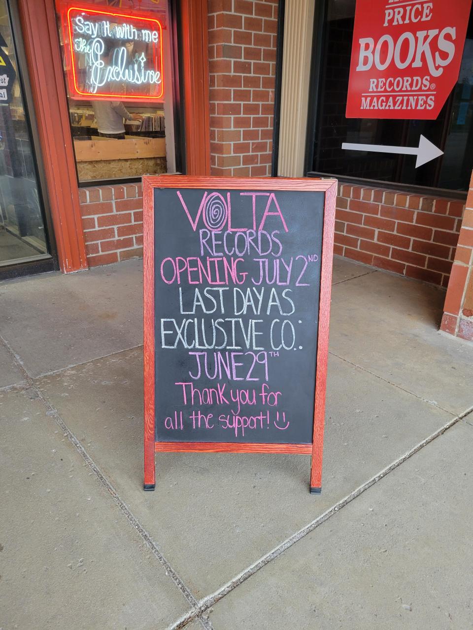 A sign outside of The Exclusive Company in Greenfield informs customers the record store will be reopening as Volta Records.