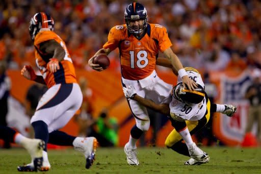 Quarterback Peyton Manning #18 of the Denver Broncos clashes linebacker Larry Foote of the Pittsburgh Steelers during the second quarter on September 9, 2012 in Denver, Colorado. Denver beat the Steelers 31-19