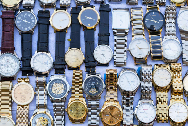 Knock-off luxury goods are displayed by sellers along a sidewalk on News  Photo - Getty Images