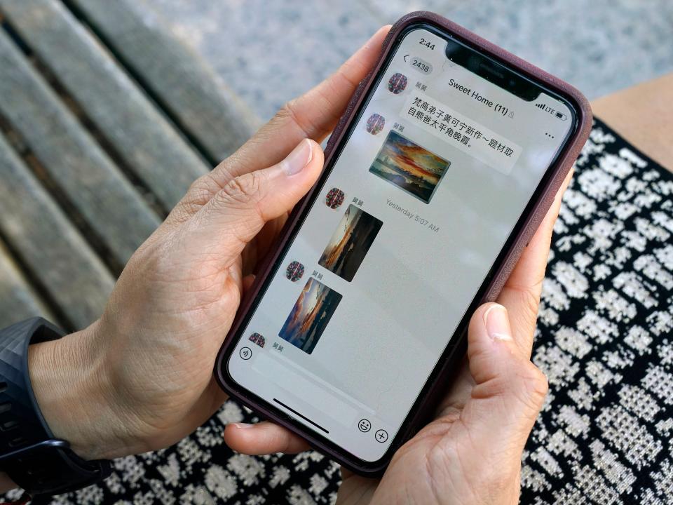 Sha Zhu, of Washington, shows the app WeChat on her phone, which she uses to keep in touch with family and friends in the U.S. and China, Tuesday Aug. 18, 2020, in Washington.