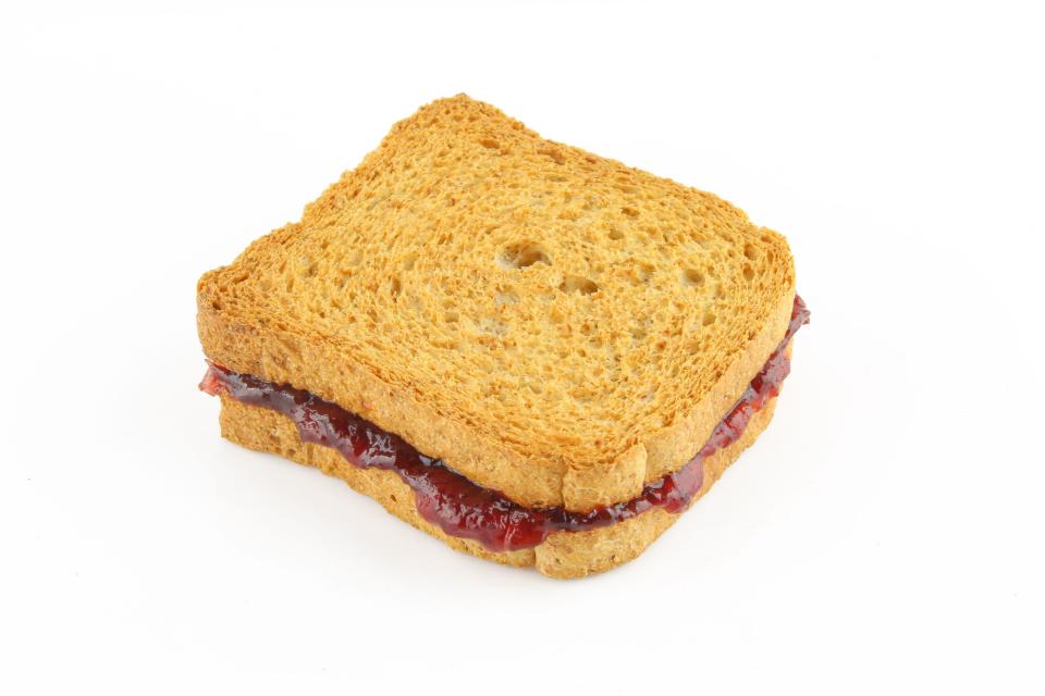 Toast sandwich with red fruit marmalade isolated on white background