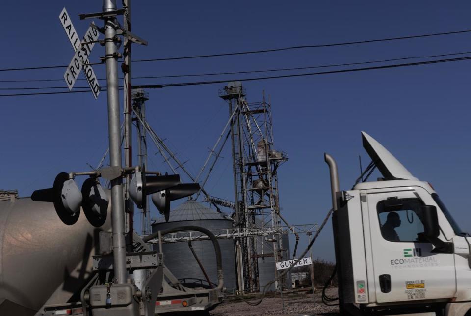 A cement trucks drive over a railroad that runs through the heart of Gunter, TX on January 11, 2024.