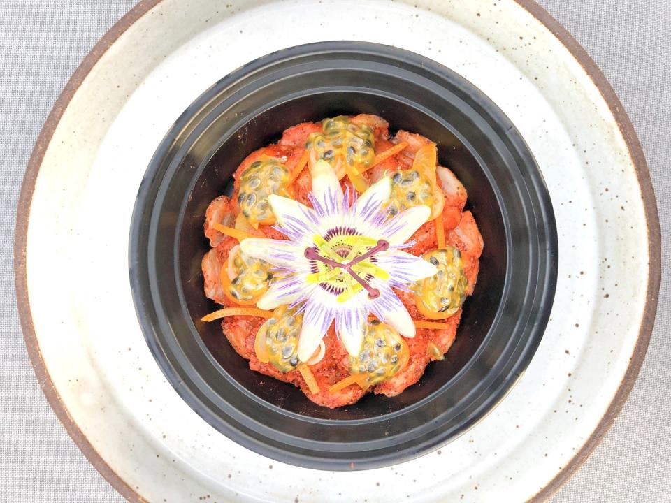 The "dry fish" dish, garnished with passiflora caerulea, from Vespertine's Yucatán takeout menu.