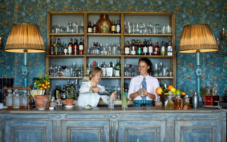 two girls behind blue bar - Jake Eastham