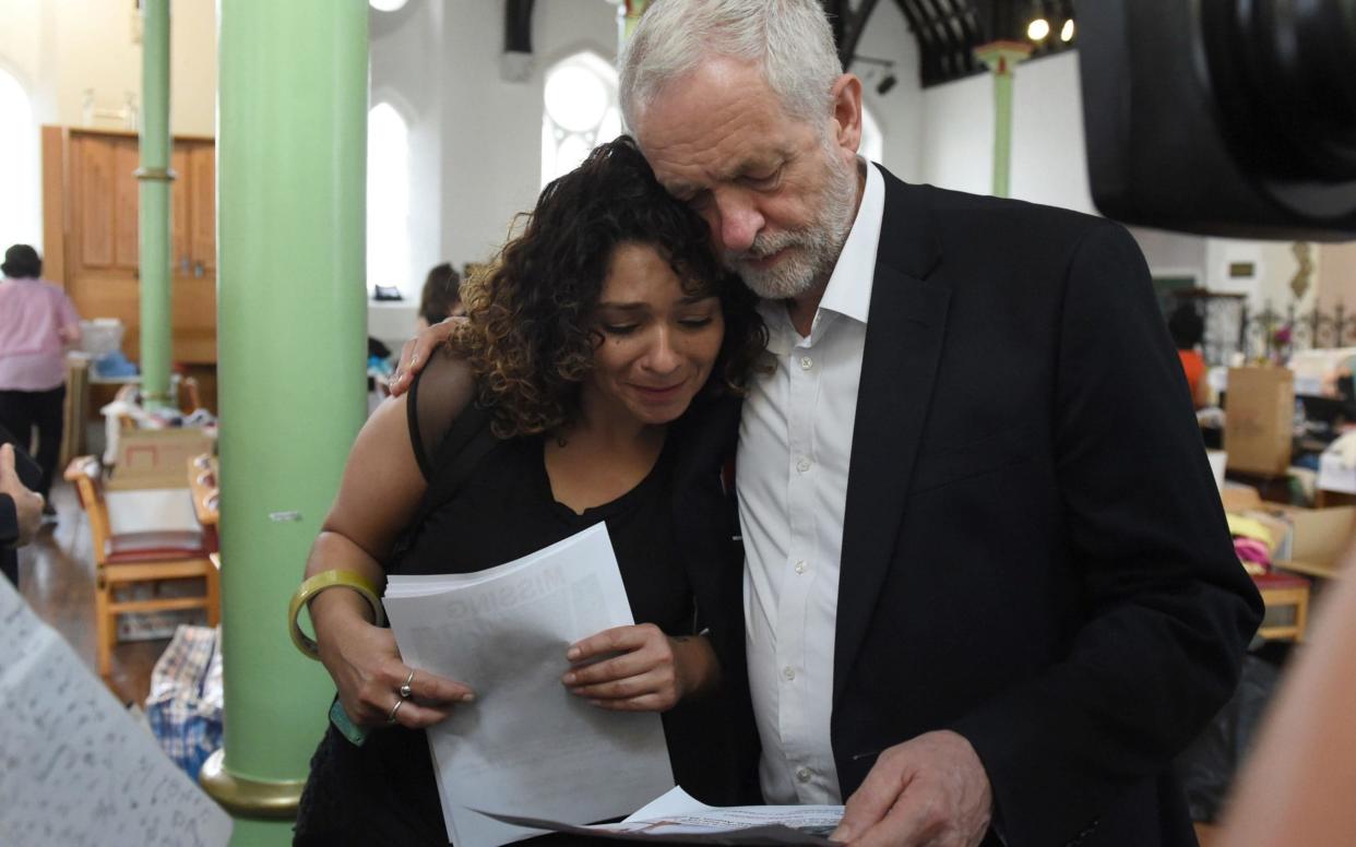 Jeremy Corbyn, the Labour leader, comforts a resident - PA