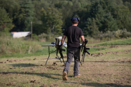 A trainee walks with his rifles as he takes part in the Cherev Gidon Firearms Training Academy in Honesdale, Pennsylvania, U.S. August 5, 2018. REUTERS/Noam Moskowitz