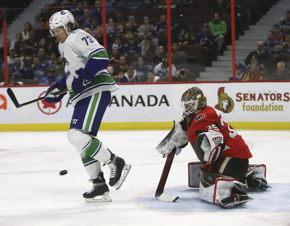 Vancouver Canucks right wing Tyler Toffoli (73) screens Ottawa Senators goaltender Marcus Hogberg (35) during first-period NHL hockey action in Ottawa, Ontario, Thursday, Feb. 27, 2020. (Fred Chartrand/The Canadian Press via AP)