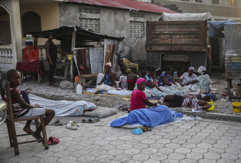 Locals begin to wake up after spending the night outside after Saturday´s 7.2 magnitude earthquake in Les Cayes, Haiti, Sunday, Aug. 15, 2021. (AP Photo/Joseph Odelyn)