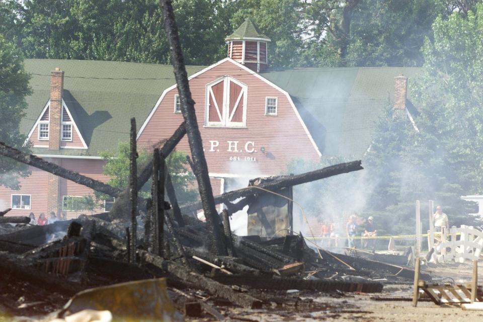 In this 2001 photo, the remains of the stables at the Gross Point Hunt Club smolder after a fire that destroyed the building and killed 19 horses.