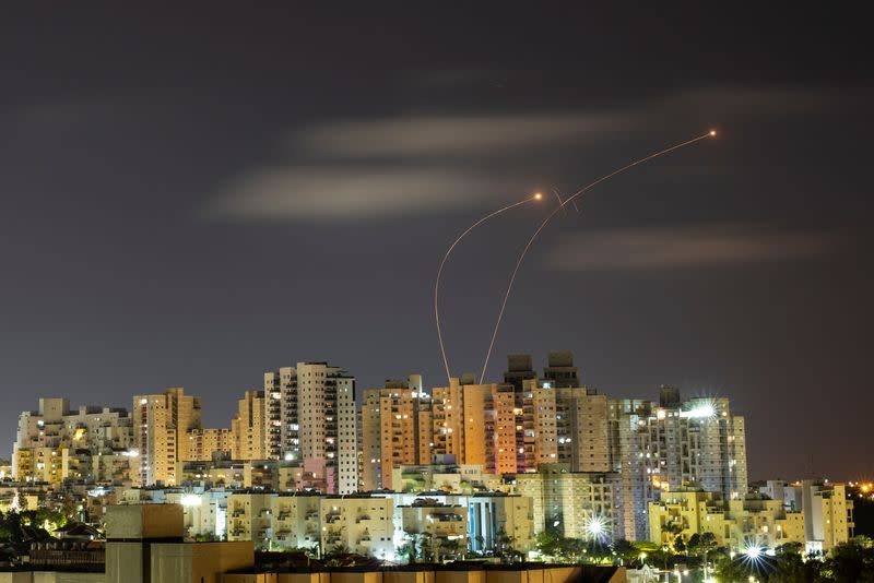 FILE PHOTO: Streaks of light are seen as Israel's Iron Dome anti-missile system intercepts rockets launched from the Gaza Strip towards Israel, as seen from Ashkelon