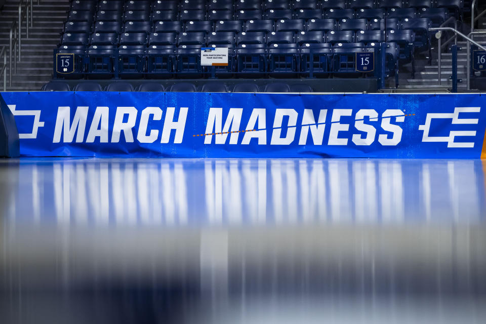 March Madness branding near the court before a first-round college basketball game between Kent State and Notre Dame in the women's NCAA Tournament Saturday March 23, 2024 in South Bend, Ind. The NCAA has presented a plan to Division I conference commissioners that would expand the lucrative men's and women's basketball tournaments by four or eight teams alongside an option to leave each field at 68 teams, according to a person familiar with the details. (AP Photo/Michael Caterina, File)