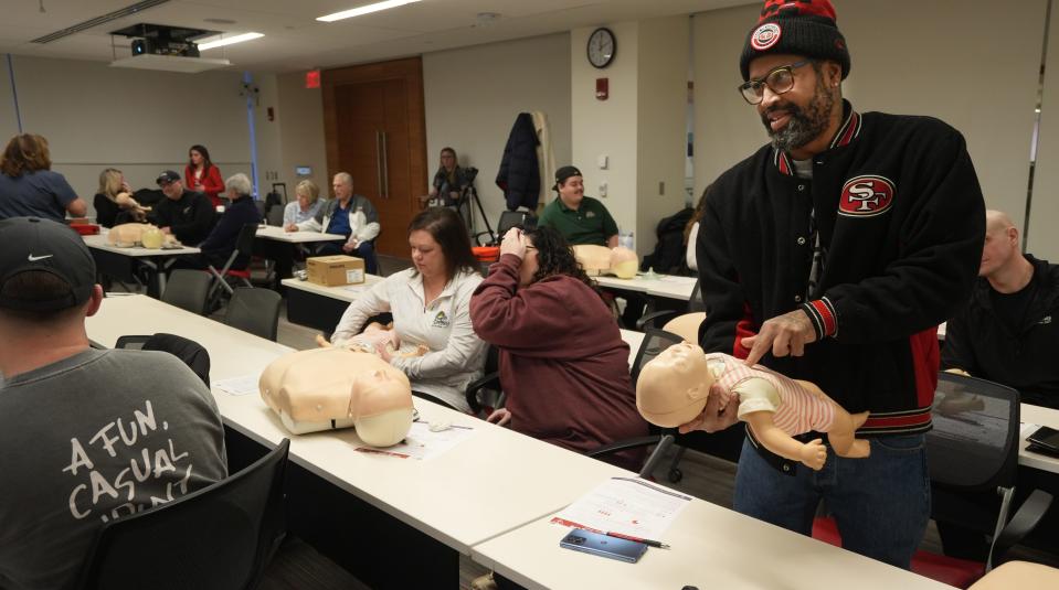 Roosters restaurant manager Carlos Bennett listens to an instructor while performing first aid on a Rescue Anne, a medical simulator used for teaching. Bennett was part of a automated external defibrillator and first aid training session held at The Ohio State University Wexner Medical Center Wednesday, Jan. 3, 2024 as the founders of Roosters restaurants are buying an AED for each of their 15 corporate restaurants. Bennett is a manager at the Huber Heights location.