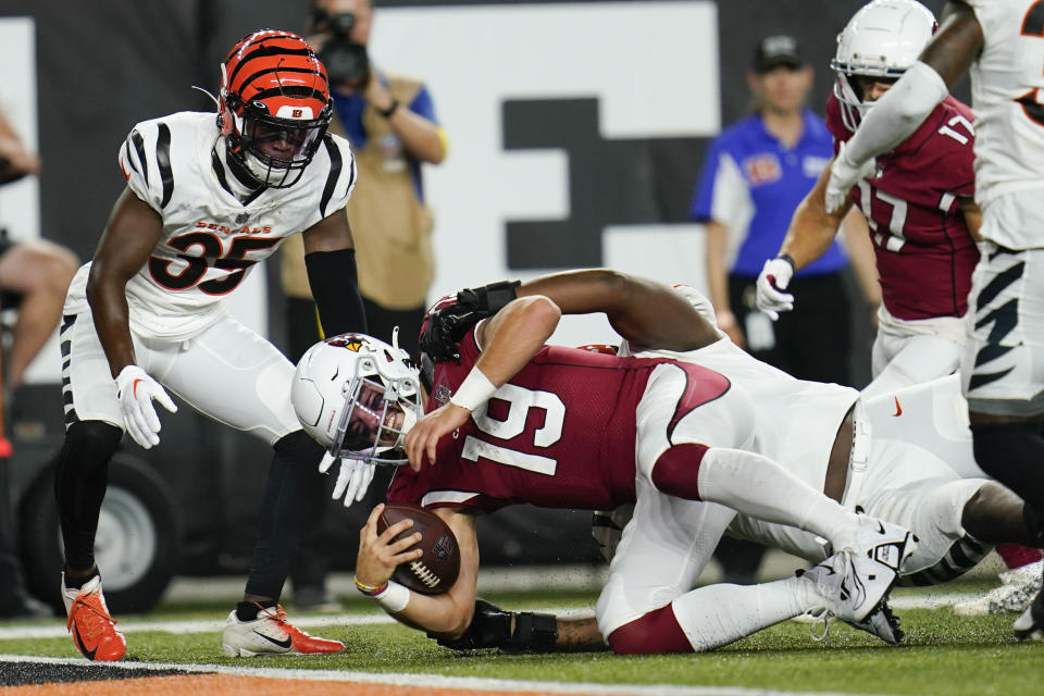 Arizona Cardinals quarterback Trace McSorley (19) is tackled by Cincinnati Bengals cornerback Cam Taylor-Britt (29) in the second quarter an NFL football preseason game in Cincinnati, Friday, Aug. 12, 2022. (AP Photo/Michael Conroy)