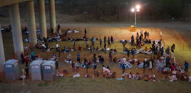 Migrant families and unaccompanied minors take refuge at a processing center under Anzalduas International Bridge in Granjeno, Texas