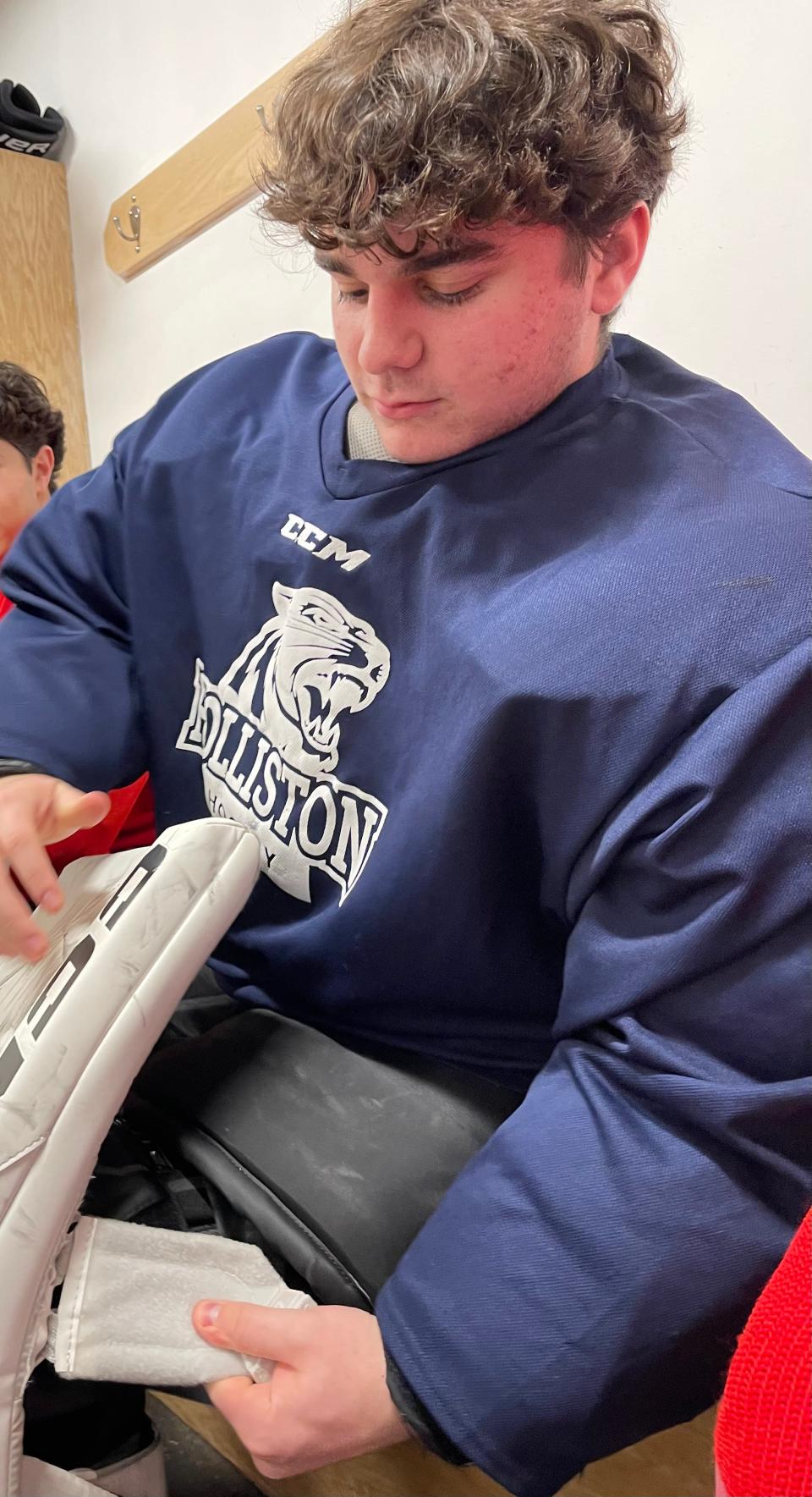 Holliston junior goalie Caleb Greenberg puts on his pads before practice at Loring Arena in Framingham on Feb. 2, 2024.