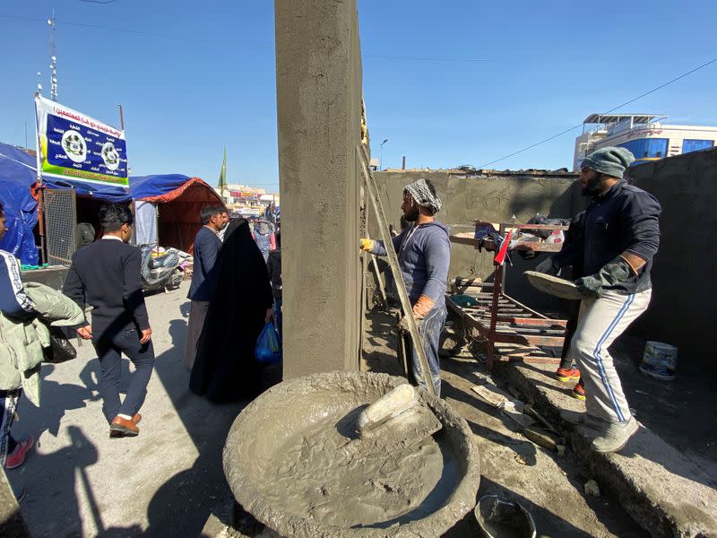 Iraqi demonstrators build camps with bricks to replace tents that were set on fire by unidentified gunmen during ongoing anti-government protests in Nassiriya