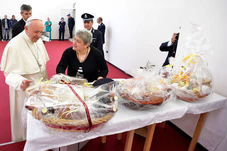 Pope Francis is presented with gifts at the Paliano prison, south of Rome, Italy April 13, 2017. Osservatore Romano/Handout via REUTERS ATTENTION EDITORS - THIS PICTURE WAS PROVIDED BY A THIRD PARTY. EDITORIAL USE ONLY. NO RESALES. NO ARCHIVE