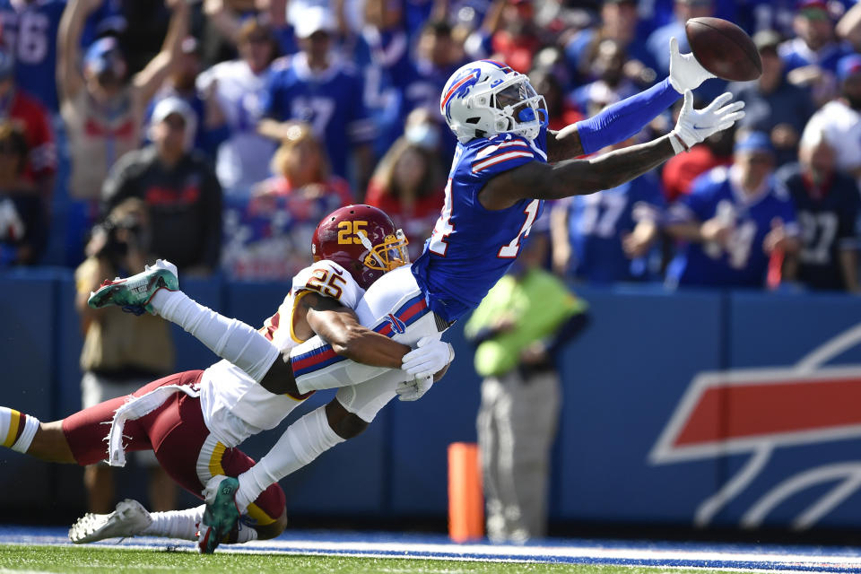 Washington Football Team's Benjamin St-Juste (25) defends Buffalo Bills' Stefon Diggs (14) during the first half of an NFL football game Sunday, Sept. 26, 2021, in Orchard Park, N.Y. The pass was incomplete. (AP Photo/Adrian Kraus)