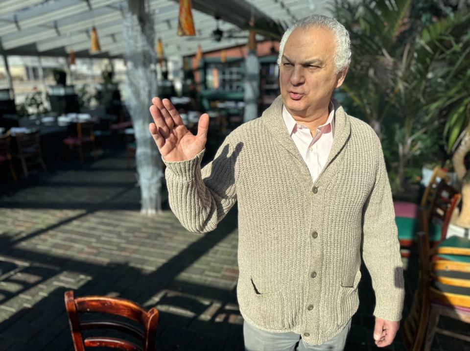 Harut Matkasyan stands in the biggest dining space of his East Providence restaurant, Riviera, which he often doesn't use anymore because business is down due to bridge traffic.
