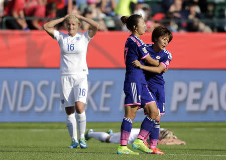 Jul 1, 2015; Edmonton, Alberta, CAN; Japan forward Yuki Ogimi (17) and midfielder Rumi Utsugi (13) celebrate as England midfielder Katie Chapman (16) reacts after a own goal by England defender Laura Bassett (on ground) during the second half in the semifinals of the FIFA 2015 Women's World Cup at Commonwealth Stadium. Mandatory Credit: Erich Schlegel-USA TODAY Sports