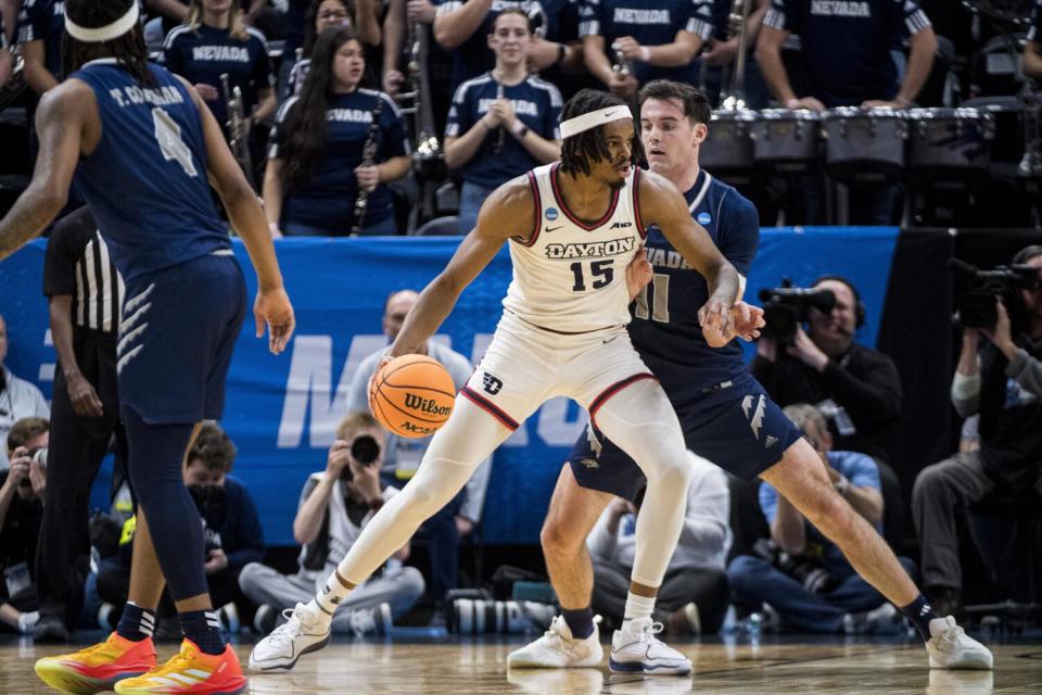 Dayton forward DaRon Holmes II backs into Nevada forward Nick Davidson during an NCAA tournament game