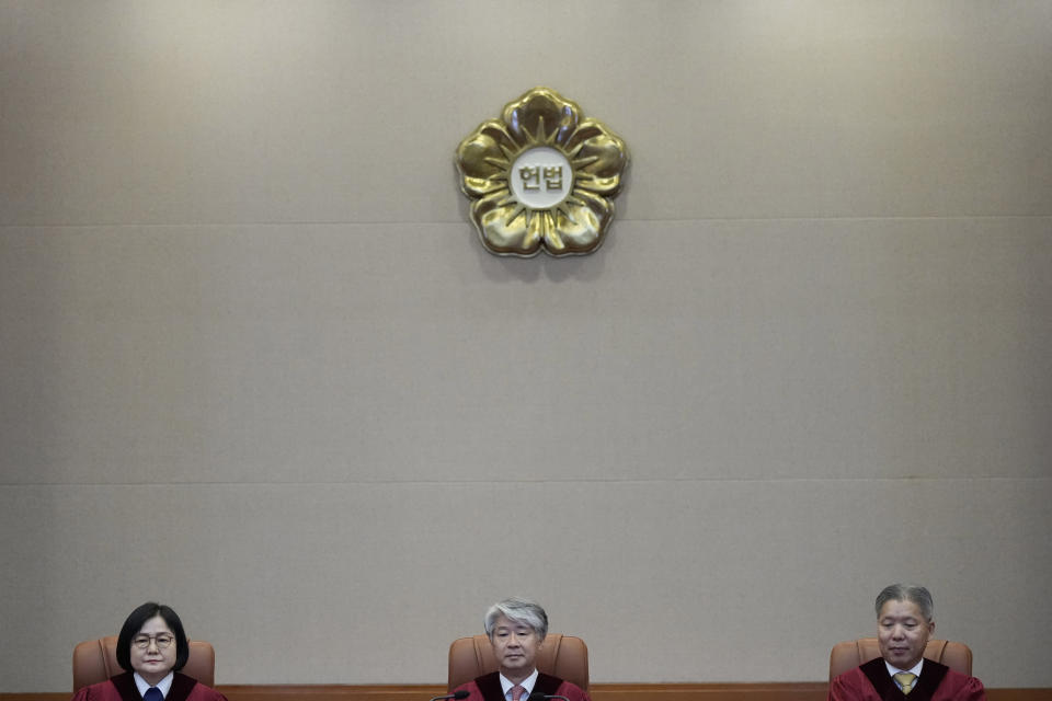 South Korea's Constitutional Court Chief Justice Lee Jong-seok, center, and other judges sit upon their arrival at the Constitutional Court in Seoul, South Korea, Thursday, Aug. 29, 2024. (AP Photo/Lee Jin-man)