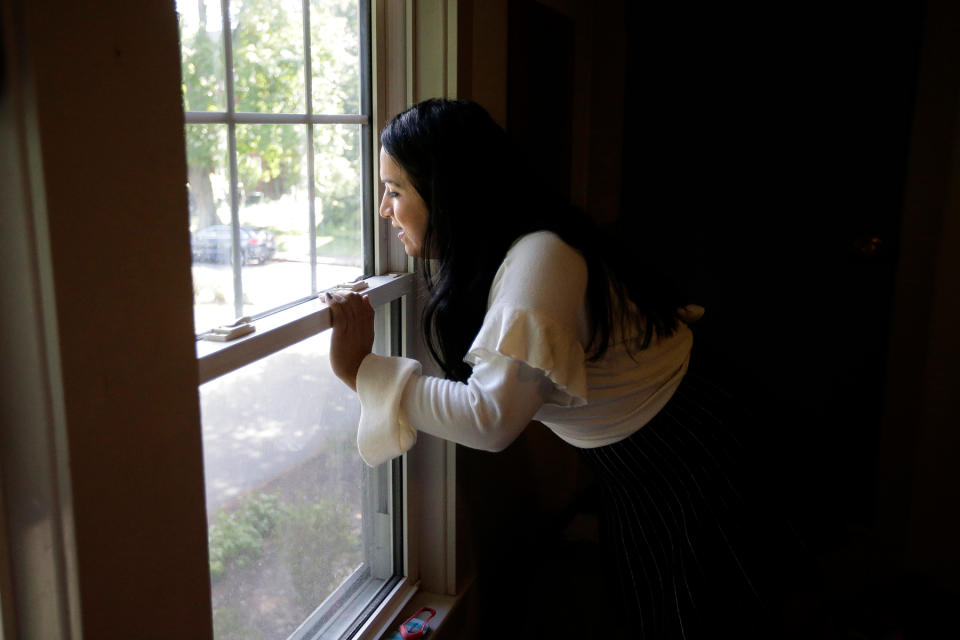 Ninotska Love, who has been accepted at Wellesley College, looks out a window in her dorm room at the women's school in Wellesley, Mass.