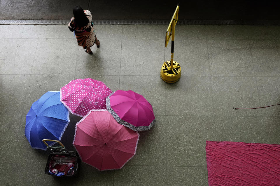 Umbrellas lay for sale at a bus station the day after presidential elections lead to a second round in Brasilia, Brazil, Monday, Oct. 3, 2022. The second round is set for Oct. 30. (AP Photo/Eraldo Peres)