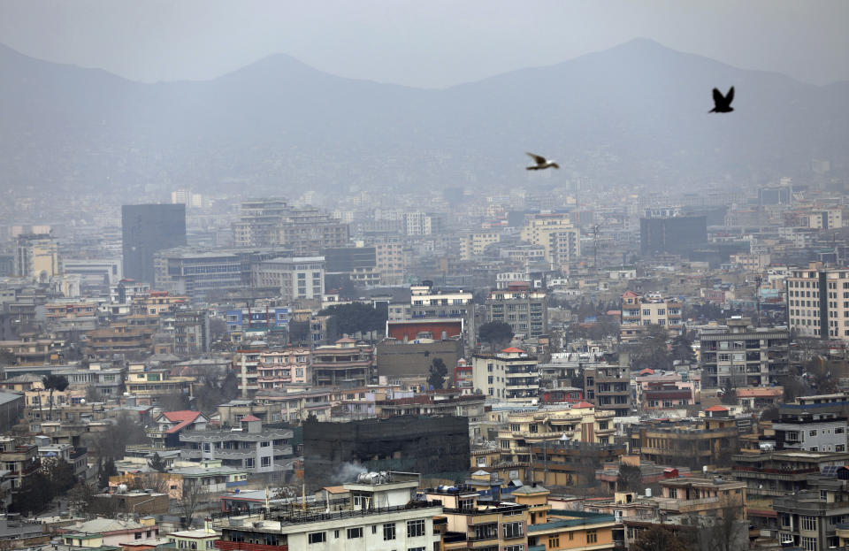 FILE - In this Feb. 1, 2021, file photo birds flyover the city of Kabul, Afghanistan. America’s longest war is approaching a crossroads. President Joe Biden’s choices in Afghanistan boil down to this: withdraw all troops by May and risk a resurgence of extremist dangers, or stay and possibly prolong the war in hopes of compelling the Taliban to make peace. (AP Photo/Rahmat Gul)