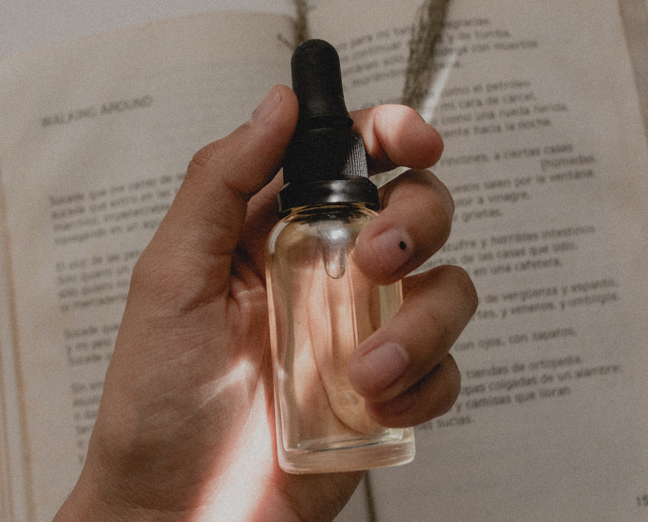 Person holding small oil bottle