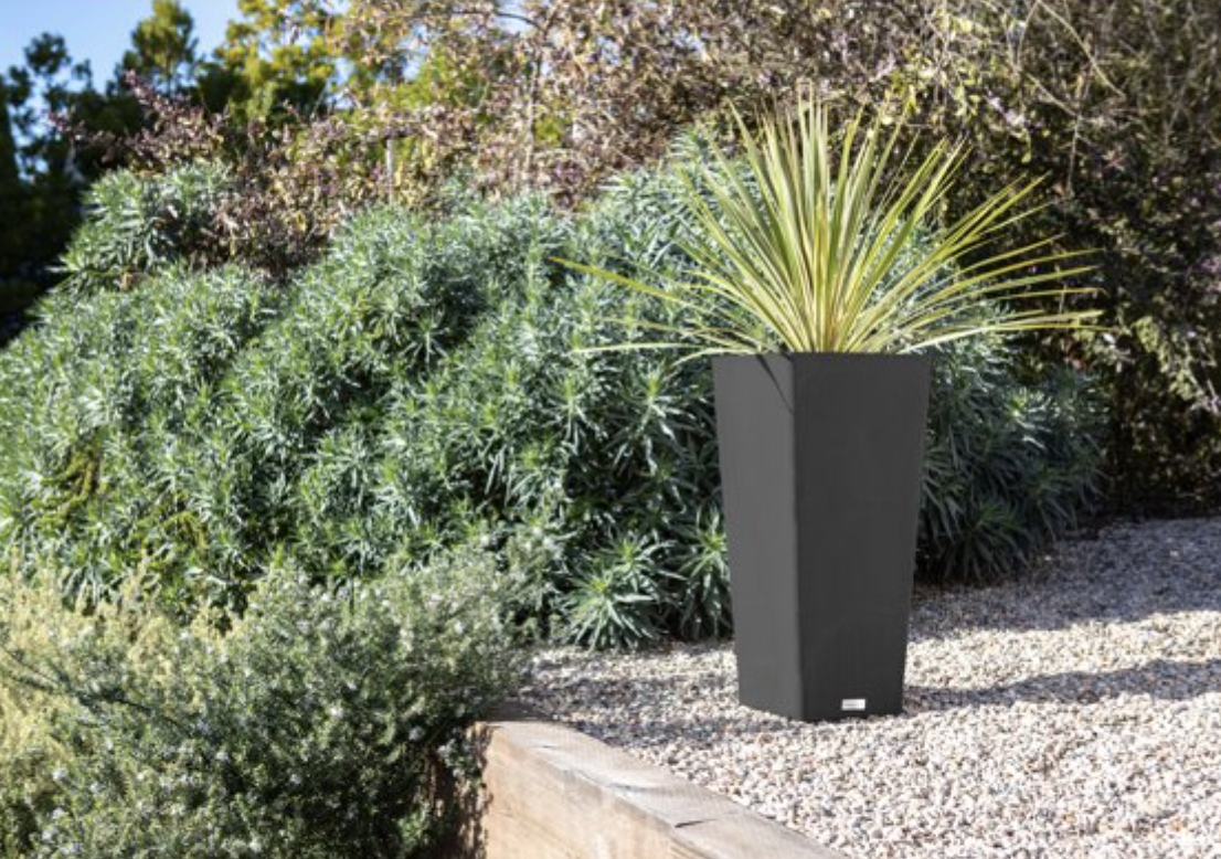Black outdoor planter in a yard