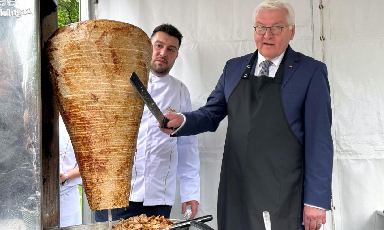 <span>Steinmeier (right) had the skewer brought specially from Berlin, and included Arif Keleş, a third-generation snack shop owner, in his delegation.</span><span>Photograph: Anadolu/Getty Images</span>